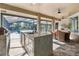 A large outdoor kitchen with a prep area, sink, refrigerator, and dining near the pool at 1384 E Lake Shore Blvd, Kissimmee, FL 34744