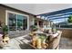 A covered lanai area provides a comfortable seating arrangement and a view of the backyard at 1384 E Lake Shore Blvd, Kissimmee, FL 34744