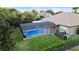 Screened-in pool with brick pavers and an umbrella-covered lounge area at 1384 E Lake Shore Blvd, Kissimmee, FL 34744
