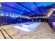 Nighttime view of the screened-in pool with inviting blue water and cozy lighting, creating a serene retreat at 1384 E Lake Shore Blvd, Kissimmee, FL 34744