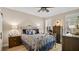 Cozy bedroom featuring a wrought iron bed and shuttered windows at 14072 Wild Majestic St, Orlando, FL 32828