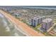 A stunning aerial view of a high-rise community along the sandy beach at 1415 Ocean Shore Blvd # 704, Ormond Beach, FL 32176