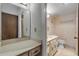 Vintage bathroom featuring dual vanities, tile floors, and private toilet and shower area at 1415 Ocean Shore Blvd # 704, Ormond Beach, FL 32176