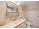 A bathroom with a white vanity, toilet and shower/tub combo with sliding glass doors at 1415 Ocean Shore Blvd # 704, Ormond Beach, FL 32176