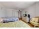 Bright bedroom featuring two beds, hard wood floor, dresser, and two closets at 1415 Ocean Shore Blvd # 704, Ormond Beach, FL 32176