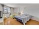 Sunny bedroom featuring two beds with quilts, a large window, and hardwood floors at 1415 Ocean Shore Blvd # 704, Ormond Beach, FL 32176