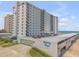 Regency Plaza condo building exterior showing parking and nearby ocean at 1415 Ocean Shore Blvd # 704, Ormond Beach, FL 32176