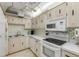 Kitchen featuring light cabinetry, appliances, and a sink at 1415 Ocean Shore Blvd # 704, Ormond Beach, FL 32176