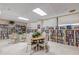 Bright library with floor to ceiling shelves filled with books, tables, and a comfortable reading area at 1415 Ocean Shore Blvd # 704, Ormond Beach, FL 32176