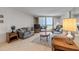 Comfortable living room with tile floors, a large sliding door to the balcony and comfortable couches at 1415 Ocean Shore Blvd # 704, Ormond Beach, FL 32176