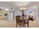 Open-concept living space flows from dining area to the living room with sliding glass door to the outside balcony at 1415 Ocean Shore Blvd # 704, Ormond Beach, FL 32176