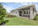 The rear of the property includes a covered porch, a well-manicured lawn and landscaping at 15491 Lebeau Loop, Winter Garden, FL 34787