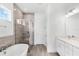 Bathroom featuring soaking tub, walk-in shower, and natural light at 15491 Lebeau Loop, Winter Garden, FL 34787