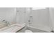 Bright bathroom featuring a tub with white tile surround, brushed nickel fixtures and a modern vanity at 15491 Lebeau Loop, Winter Garden, FL 34787