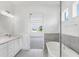 Bathroom boasts double sink vanity, soaking tub, and natural light at 15491 Lebeau Loop, Winter Garden, FL 34787