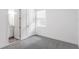 An empty room featuring a window and light-grey carpet that connects to a bathroom at 15491 Lebeau Loop, Winter Garden, FL 34787