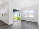 Dining room with modern light fixture and view of back yard through sliding glass door at 15491 Lebeau Loop, Winter Garden, FL 34787