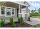 Well-manicured front yard with green plants and a brick walkway leading to a home with white trim accents at 15491 Lebeau Loop, Winter Garden, FL 34787