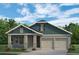 Charming single-story home with blue siding, a two-car garage, and landscaped front yard at 15491 Lebeau Loop, Winter Garden, FL 34787