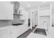 Modern kitchen featuring stainless steel appliances, white cabinetry, a tile backsplash, and a kitchen island at 15491 Lebeau Loop, Winter Garden, FL 34787