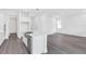Bright, modern kitchen with white cabinets, stainless steel appliances, and a large island with sink at 15491 Lebeau Loop, Winter Garden, FL 34787
