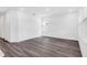 Bright, open living room featuring hardwood floors, white walls, and abundant natural light from the windows at 15491 Lebeau Loop, Winter Garden, FL 34787
