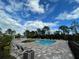 Relaxing community pool with lounge chairs and beautiful landscaping for residents to enjoy at 15491 Lebeau Loop, Winter Garden, FL 34787