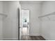 Walk-in closet leading into bathroom with tile flooring and wire shelving at 15491 Lebeau Loop, Winter Garden, FL 34787