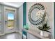 Bright foyer with a view outside, decorator mirror, light gray color scheme and decorative vases at 1699 Three Bars Rd, Kissimmee, FL 34744