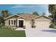 Charming single-Gathering home featuring a two-car garage, manicured lawn, and neutral-toned facade at 1700 Three Bars Rd, Kissimmee, FL 34744