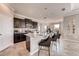 Open kitchen featuring dark cabinets, granite countertops, tile flooring, and a breakfast bar at 1700 Three Bars Rd, Kissimmee, FL 34744