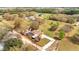 Aerial of property with enclosed pool, accessory buildings, and mature landscaping at 1775 Druliner Rd, St Cloud, FL 34771