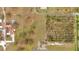 Wide aerial shot of the property showing large acreage, outbuildings, and surrounding vegetation at 1775 Druliner Rd, St Cloud, FL 34771