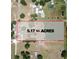 Aerial view of a 5.17 acre property featuring a residence, pool, outbuildings, and treed areas at 1775 Druliner Rd, St Cloud, FL 34771
