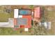 Aerial view of property featuring a pool, a red roof, landscaping, and multiple outbuildings at 1775 Druliner Rd, St Cloud, FL 34771