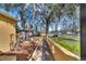 Tranquil backyard view with a covered pergola, established garden beds, and mature trees at 1775 Druliner Rd, St Cloud, FL 34771