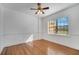 Bedroom features hardwood floors, ceiling fan, and a large window at 1775 Druliner Rd, St Cloud, FL 34771