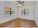Bright bedroom with hardwood floors, ceiling fan, and large windows at 1775 Druliner Rd, St Cloud, FL 34771