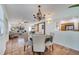 Inviting dining area with stylish chandelier, seamlessly connected to the living room and kitchen at 1775 Druliner Rd, St Cloud, FL 34771