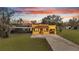 Charming home exterior featuring a screened pool and a spacious front yard and driveway at 1775 Druliner Rd, St Cloud, FL 34771