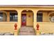 Charming front entrance with decorative red door, tiled steps and inviting curb appeal at 1775 Druliner Rd, St Cloud, FL 34771