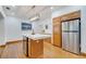 Kitchen with wooden cabinets, a large island with seating, stainless steel refrigerator, and modern lighting at 1775 Druliner Rd, St Cloud, FL 34771