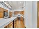 Kitchen featuring stainless steel appliances, white countertops, wood cabinets and floors, and modern lighting at 1775 Druliner Rd, St Cloud, FL 34771