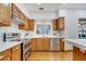 Bright kitchen with stainless steel appliances, white countertops and backsplash, and wooden cabinets at 1775 Druliner Rd, St Cloud, FL 34771