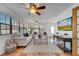 Spacious living room with tile floors, natural light, neutral furniture, and a ceiling fan at 1775 Druliner Rd, St Cloud, FL 34771