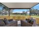 Covered patio with seating and a view of the well-manicured lawn at 1775 Druliner Rd, St Cloud, FL 34771