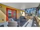 Outdoor covered patio featuring neutral furniture, a ceiling and a pair of red French doors at 1775 Druliner Rd, St Cloud, FL 34771