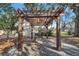 View of backyard pergola, an entertainment area, with access to additional building at 1775 Druliner Rd, St Cloud, FL 34771