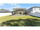 View of the property's backyard with a screened-in pool and well-maintained lawn at 2564 Bullion Loop, Sanford, FL 32771