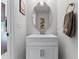 Bathroom with a white vanity, oval mirror, and chrome fixtures, plus a hand towel hanging on a bronze hook at 2564 Bullion Loop, Sanford, FL 32771